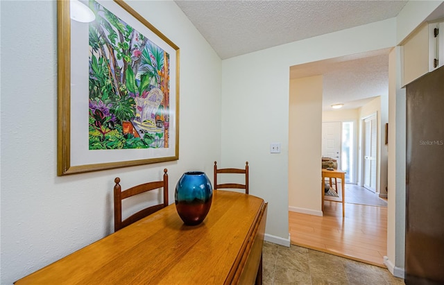 368 Perth Ct Unit 368, Dunedin, FL 34698 - dining space with a textured ceiling and baseboards