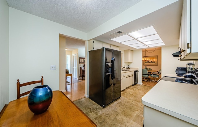 368 Perth Ct Unit 368, Dunedin, FL 34698 - kitchen with black appliances, a sink, light countertops, white cabinetry, and ventilation hood