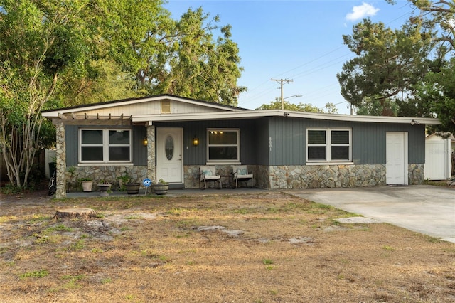 8001 N Ola Ave, Tampa, FL 33604 - view of front facade featuring stone siding and covered porch