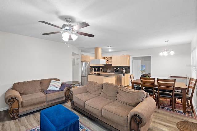 8001 N Ola Ave, Tampa, FL 33604 - living area featuring light wood finished floors, a chandelier, and a ceiling fan