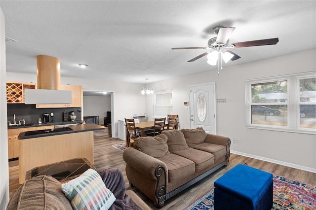 8001 N Ola Ave, Tampa, FL 33604 - living room with a ceiling fan, wood finished floors, a chandelier, and baseboards