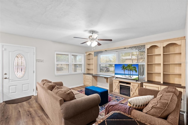 8001 N Ola Ave, Tampa, FL 33604 - living room featuring a ceiling fan, a textured ceiling, wood finished floors, plenty of natural light, and baseboards