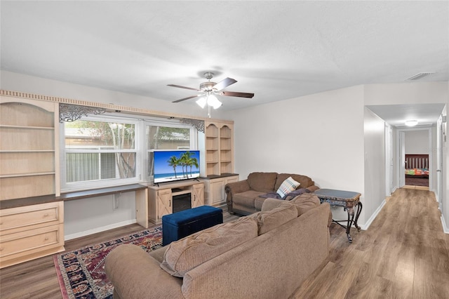 8001 N Ola Ave, Tampa, FL 33604 - living room with wood finished floors, ceiling fan, and baseboards