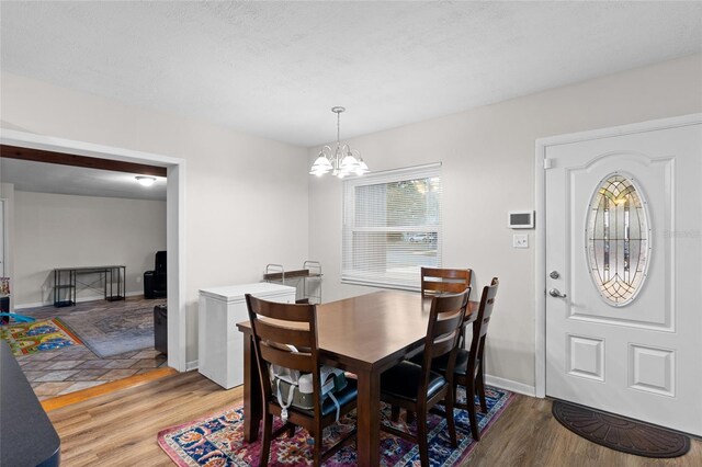 8001 N Ola Ave, Tampa, FL 33604 - dining room featuring light wood-style floors, a chandelier, and baseboards