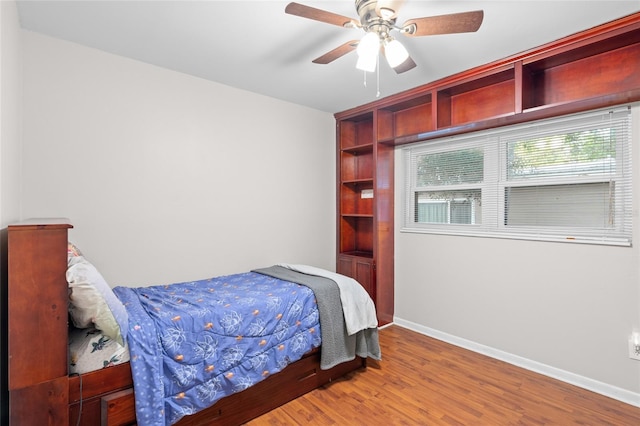 8001 N Ola Ave, Tampa, FL 33604 - bedroom with baseboards, wood finished floors, and ceiling fan