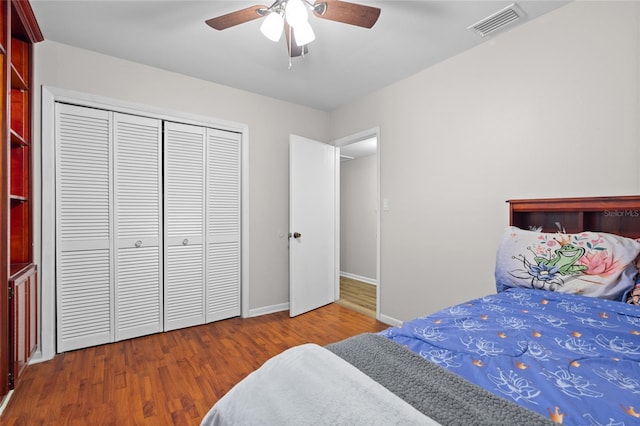 8001 N Ola Ave, Tampa, FL 33604 - bedroom with a closet, baseboards, wood finished floors, and a ceiling fan