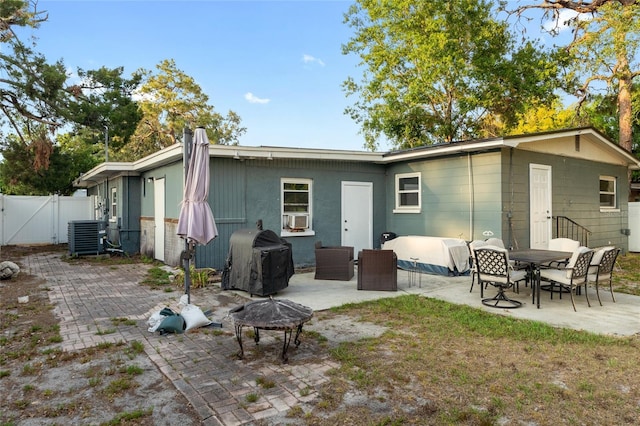 8001 N Ola Ave, Tampa, FL 33604 - rear view of property with a fire pit, a gate, a patio area, central AC unit, and fence