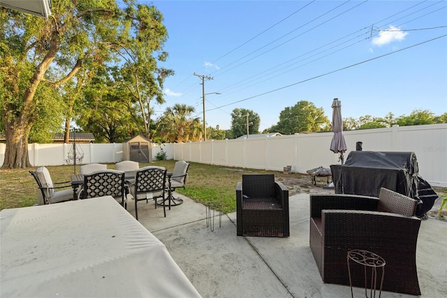 8001 N Ola Ave, Tampa, FL 33604 - view of patio / terrace with outdoor dining area, a storage shed, a fenced backyard, an outdoor structure, and an outdoor hangout area