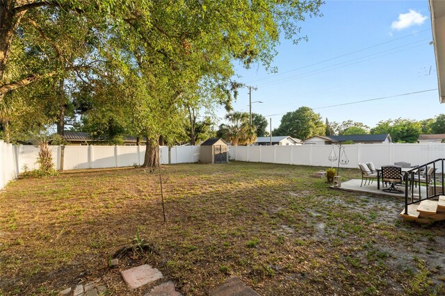 8001 N Ola Ave, Tampa, FL 33604 - fenced backyard featuring a shed, a patio area, and an outdoor structure