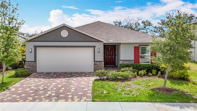 3891 Reflection Dock Dr, Seffner, FL 33584 - ranch-style house featuring stone siding, stucco siding, decorative driveway, an attached garage, and roof with shingles