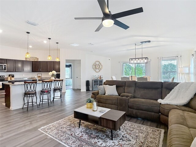 3891 Reflection Dock Dr, Seffner, FL 33584 - living area with a ceiling fan, light wood-style floors, and recessed lighting