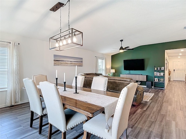 3891 Reflection Dock Dr, Seffner, FL 33584 - dining room with vaulted ceiling, ceiling fan, wood finished floors, and baseboards