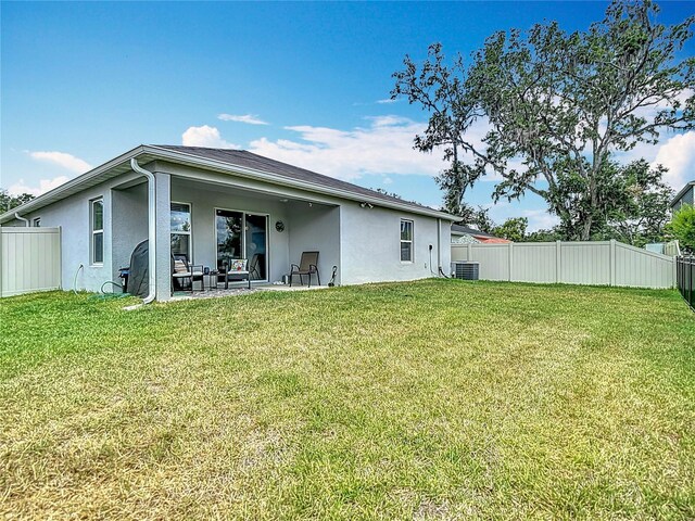 3891 Reflection Dock Dr, Seffner, FL 33584 - rear view of property featuring stucco siding, cooling unit, and a patio area