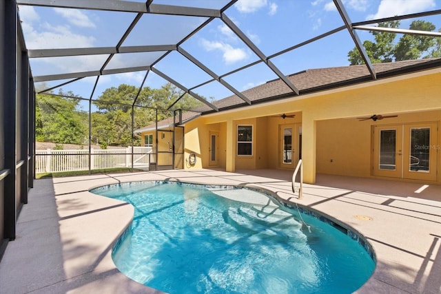 view of pool with ceiling fan, a patio, fence, and a lanai