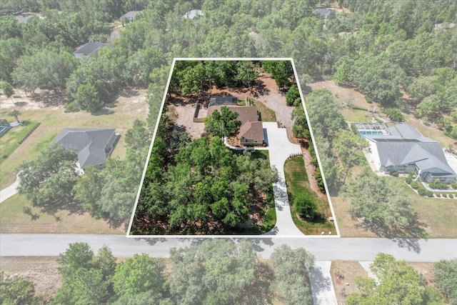 aerial view of property and surrounding area featuring property parcel outlined