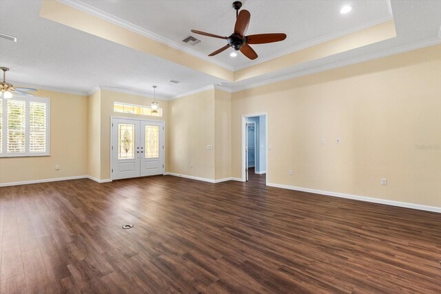 spare room with a ceiling fan, a raised ceiling, french doors, crown molding, and dark wood-style floors