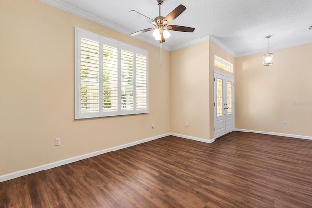 empty room featuring crown molding, wood finished floors, baseboards, ceiling fan, and a textured ceiling
