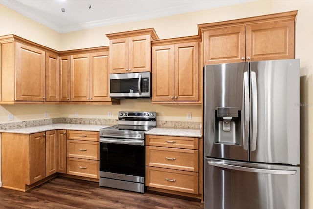 kitchen featuring appliances with stainless steel finishes, dark wood-style flooring, light stone counters, and ornamental molding