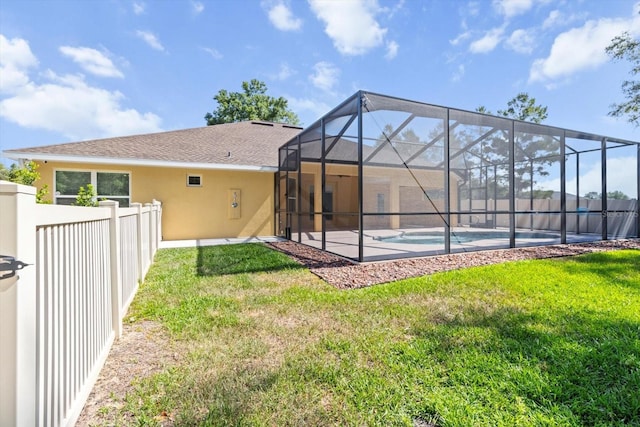 back of property with stucco siding, a patio area, and a lanai