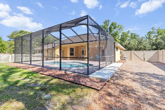 back of house featuring a fenced backyard, a gate, and a patio area