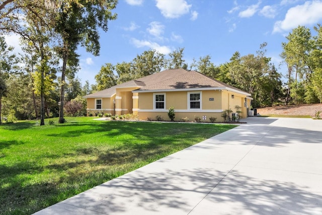single story home featuring driveway, stucco siding, a front yard, and a garage