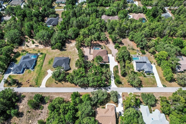 aerial view of property and surrounding area featuring nearby suburban area