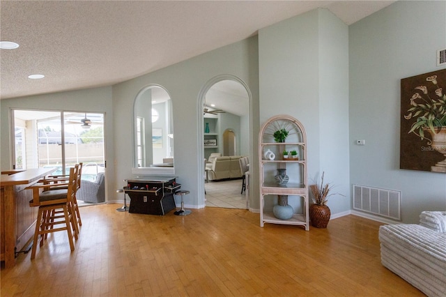 7838 Trail Run Loop, New Port Richey, FL 34653 - dining room featuring a ceiling fan, vaulted ceiling, wood finished floors, arched walkways, and baseboards