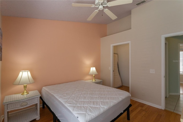 7838 Trail Run Loop, New Port Richey, FL 34653 - bedroom featuring wood finished floors, baseboards, vaulted ceiling, and a ceiling fan