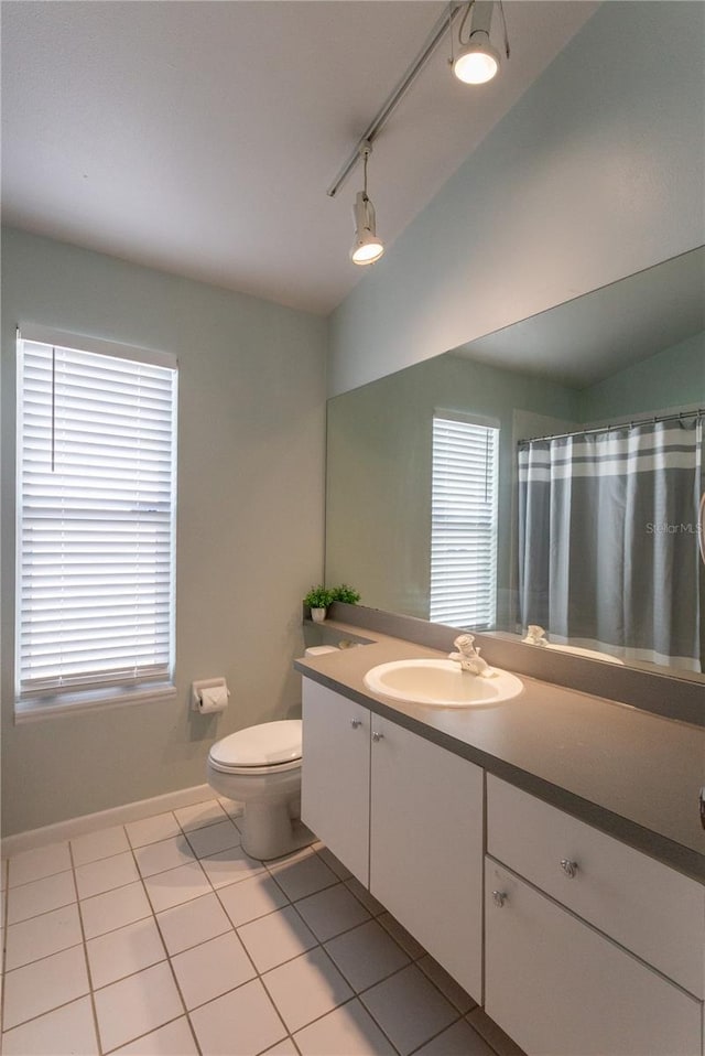 7838 Trail Run Loop, New Port Richey, FL 34653 - full bath with tile patterned floors, toilet, vanity, baseboards, and track lighting