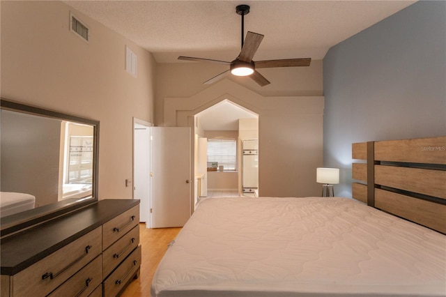 7838 Trail Run Loop, New Port Richey, FL 34653 - bedroom with light wood-style flooring, connected bathroom, and ceiling fan