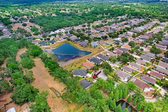 aerial view of property's location featuring a large body of water and nearby suburban area