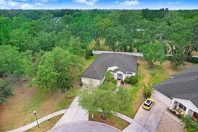 view from above of property with a heavily wooded area