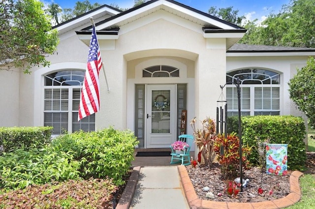 property entrance featuring stucco siding