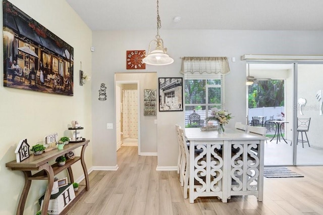 dining space featuring light wood-type flooring and baseboards