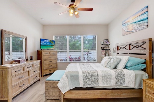 bedroom with light wood finished floors and ceiling fan