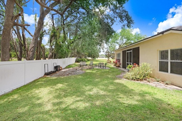 view of yard with a sunroom and an outdoor fire pit
