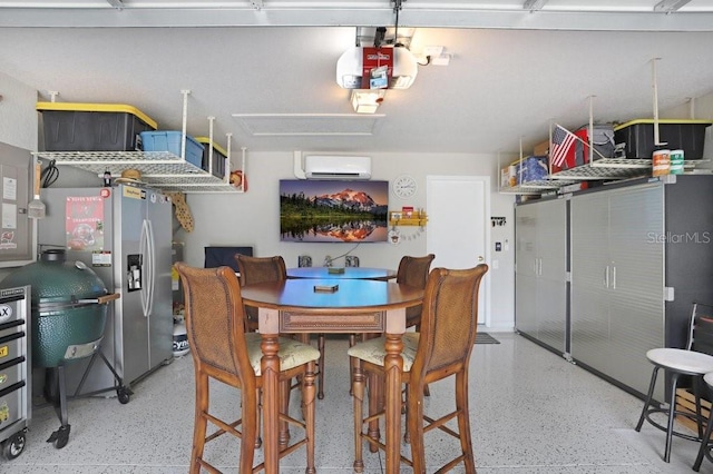 garage featuring stainless steel fridge, a wall mounted AC, and a garage door opener