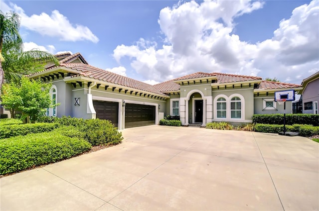 5728 Watercolor Dr, Lithia, FL 33547 - mediterranean / spanish home featuring stucco siding, an attached garage, concrete driveway, and a tiled roof