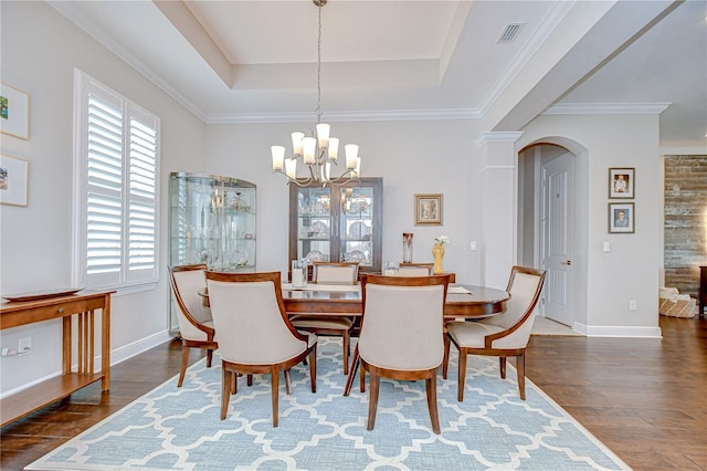 5728 Watercolor Dr, Lithia, FL 33547 - dining area with a chandelier, arched walkways, plenty of natural light, and wood finished floors