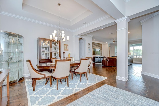 5728 Watercolor Dr, Lithia, FL 33547 - dining space featuring decorative columns, dark wood-style floors, a chandelier, baseboards, and a ceiling fan