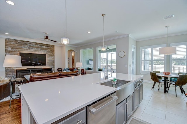 5728 Watercolor Dr, Lithia, FL 33547 - kitchen featuring stainless steel dishwasher, gray cabinets, a ceiling fan, ornamental molding, and light countertops