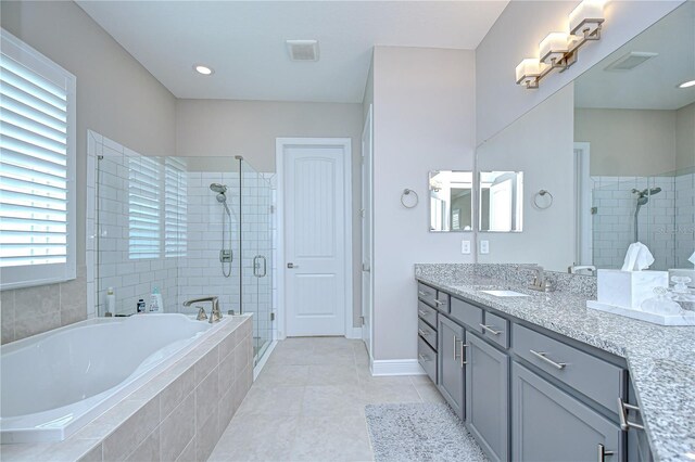 5728 Watercolor Dr, Lithia, FL 33547 - full bath with a shower stall, a bath, vanity, tile patterned floors, and baseboards