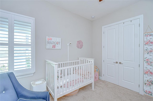 5728 Watercolor Dr, Lithia, FL 33547 - bedroom with a closet, a crib, and carpet floors