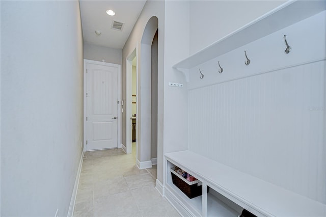 5728 Watercolor Dr, Lithia, FL 33547 - mudroom with arched walkways, light tile patterned floors, and baseboards