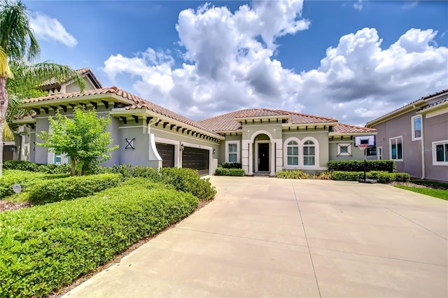 5728 Watercolor Dr, Lithia, FL 33547 - mediterranean / spanish-style house with an attached garage, driveway, stucco siding, and a tile roof