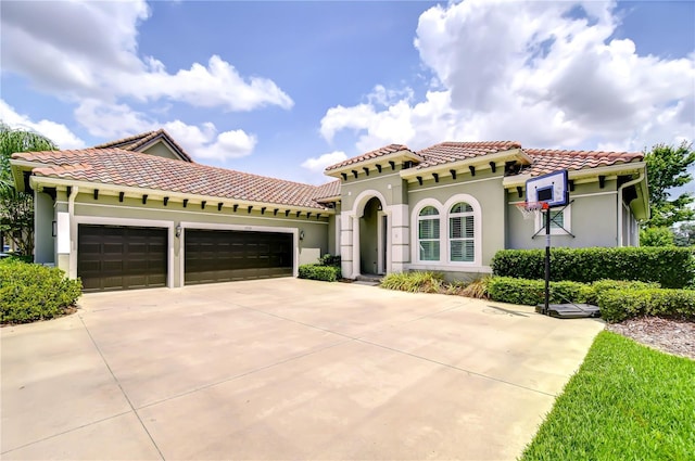 5728 Watercolor Dr, Lithia, FL 33547 - mediterranean / spanish house featuring stucco siding, an attached garage, concrete driveway, and a tiled roof