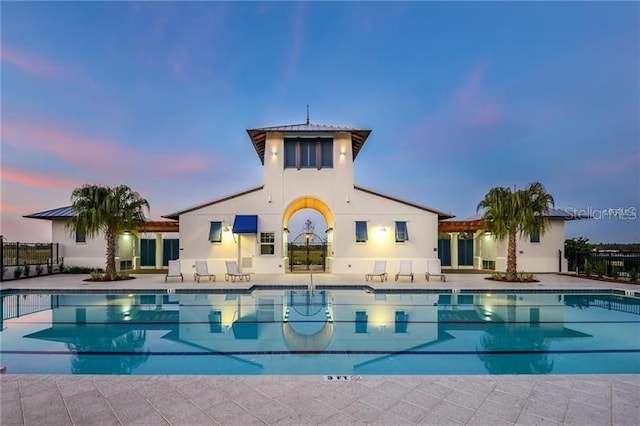 5728 Watercolor Dr, Lithia, FL 33547 - rear view of house with a community pool, stucco siding, and a patio area