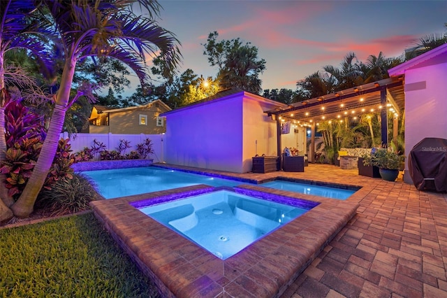 1436 30th Ave N, Saint Petersburg, FL 33704 - pool at dusk featuring an in-ground hot tub, area for grilling, a fenced backyard, and a patio area
