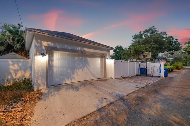 1436 30th Ave N, Saint Petersburg, FL 33704 - garage at dusk featuring fence