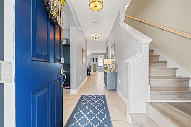1436 30th Ave N, Saint Petersburg, FL 33704 - entrance foyer with stairs, arched walkways, and light tile patterned flooring